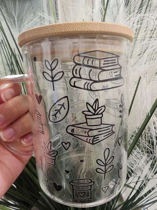 Books and Coffee mug w/ bamboo lid and glass straw